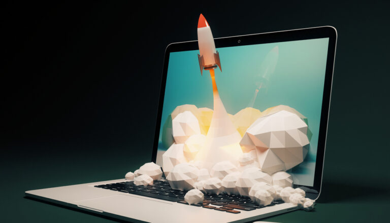 Website design with a rocket launching out of the laptop