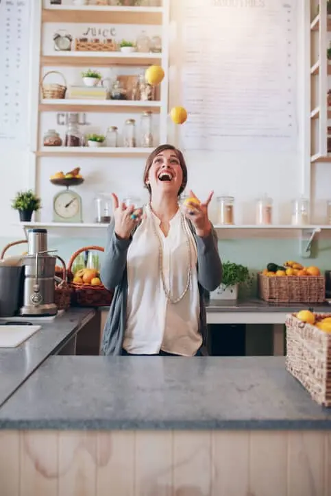 Happy Business Owner Smiling and Juggling as she uses Synergise Business Solutions the Marketing Agency for Small Businesses
